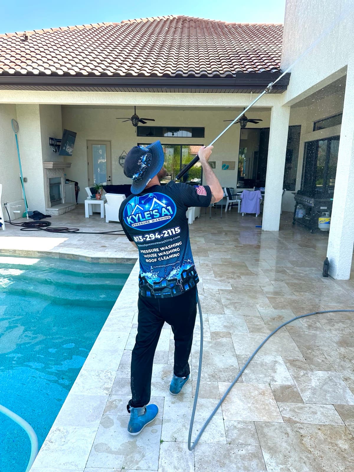 Soft washing house exterior near pool deck