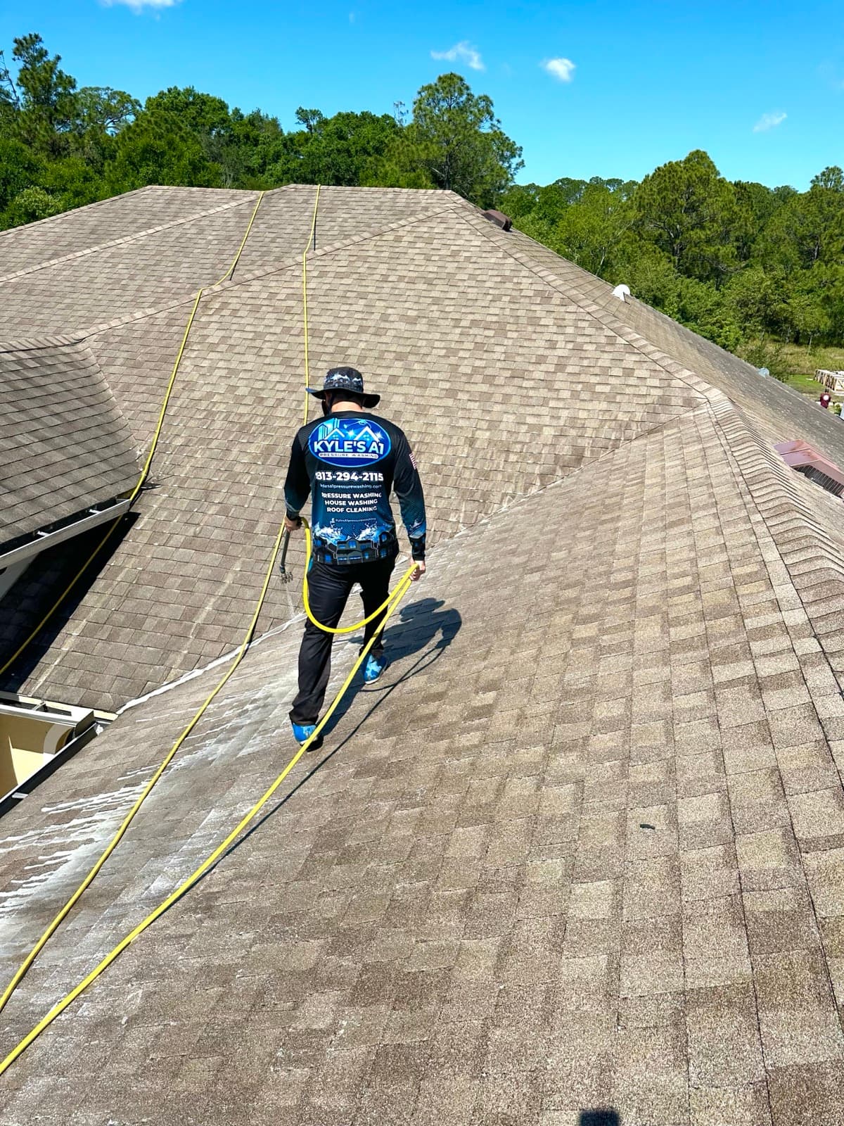 Kyle's A1 soft wash technician on roof