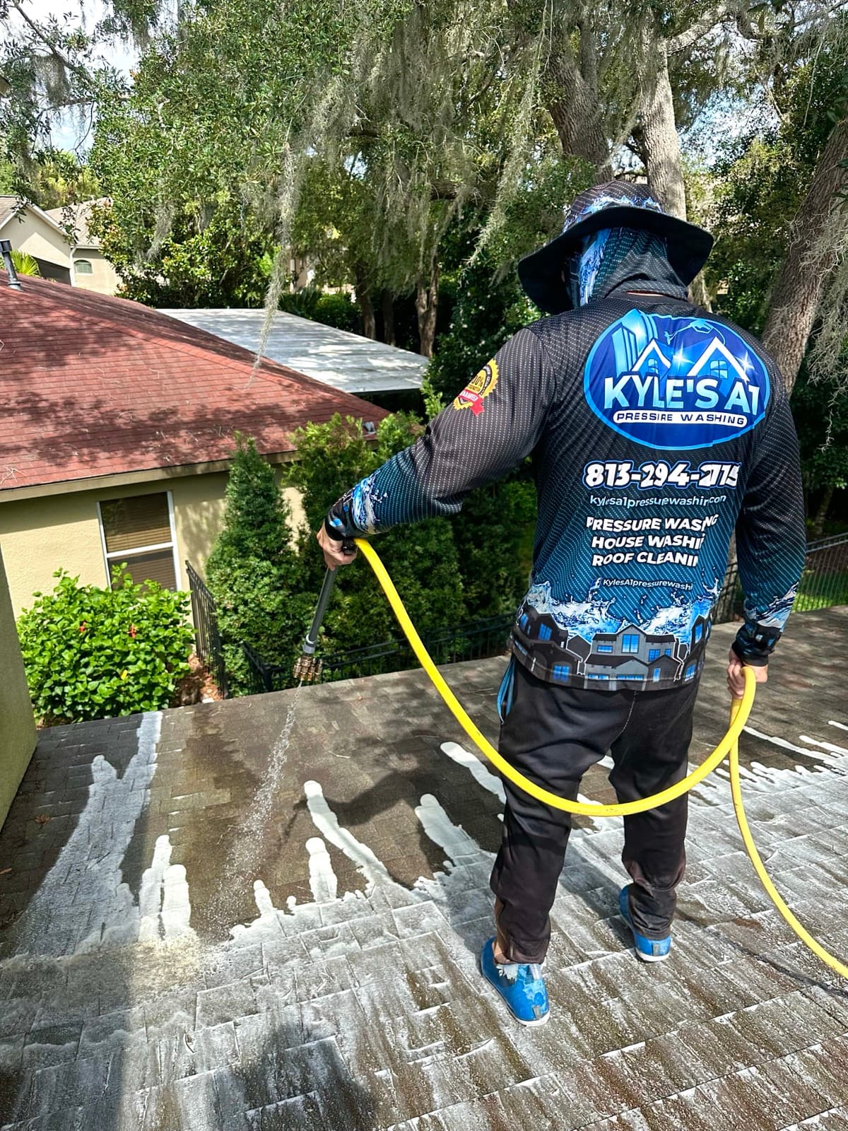 Professional roof washing close-up - branded uniform