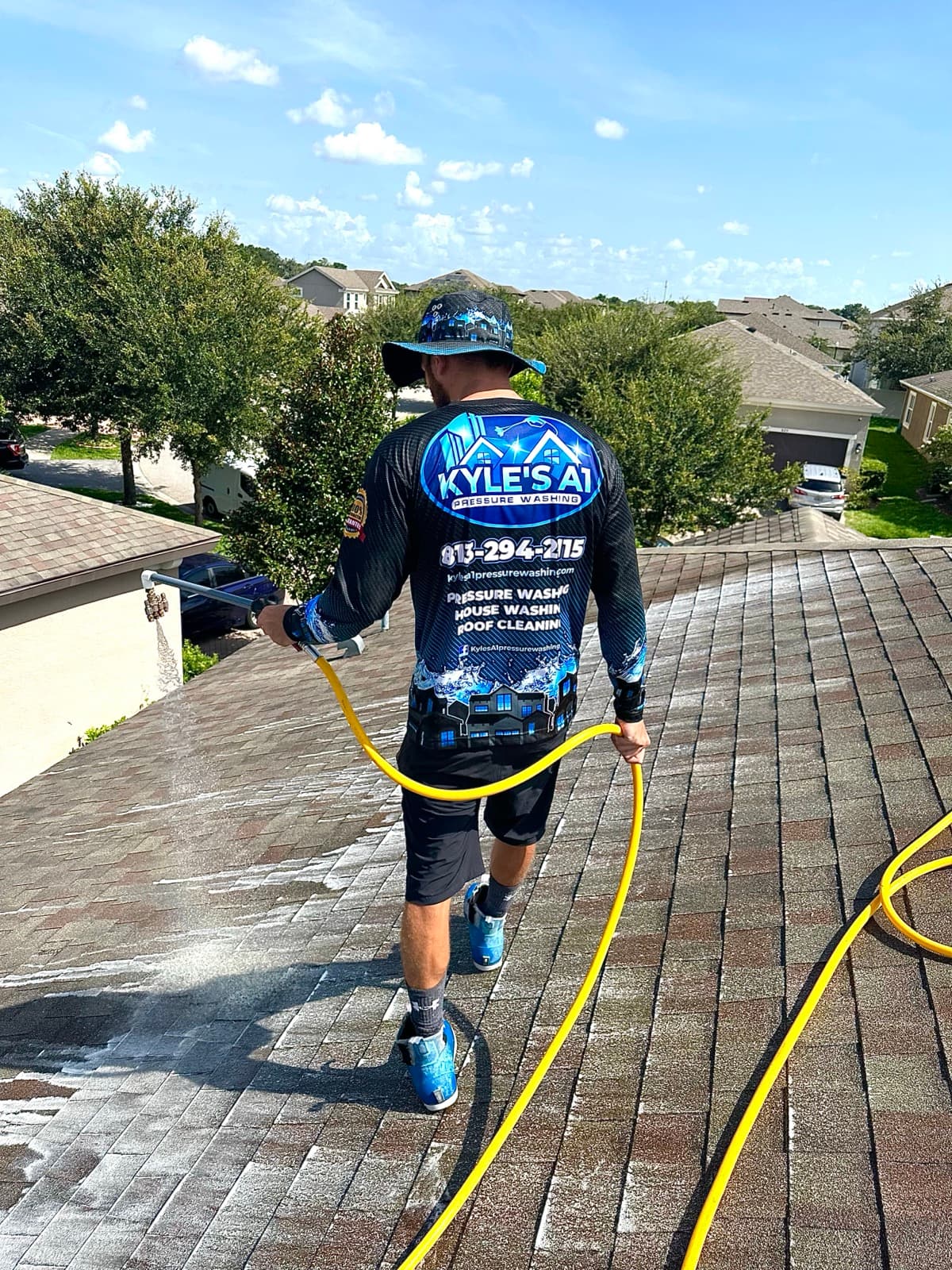 Kyle's A1 crew member soft washing roof shingles